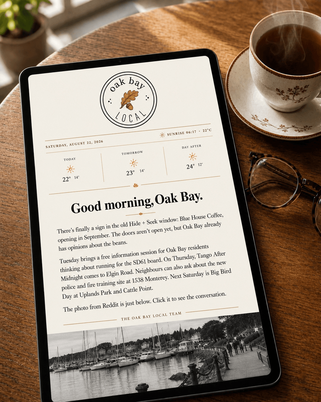 Oak Bay Local displayed on a tablet beside a cup of tea