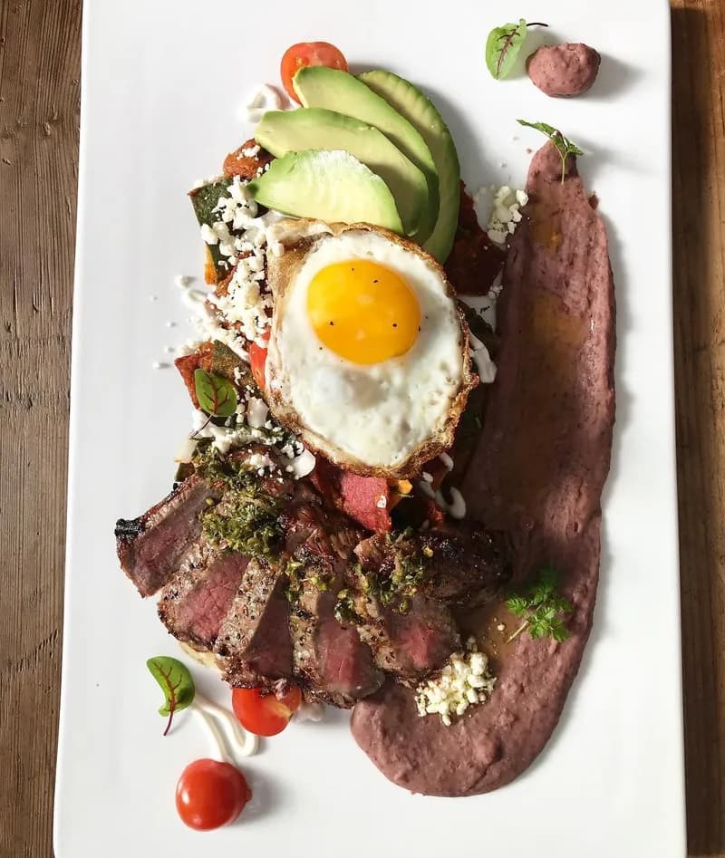 Steak and eggs with avocado, chimichurri and refried beans at Liv Café & Bistro