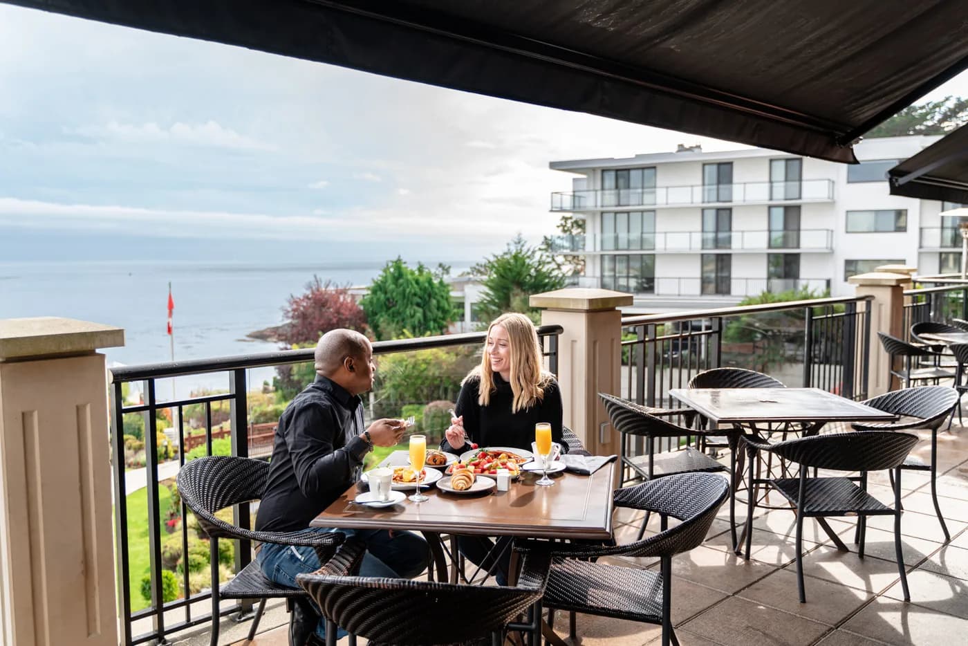 Diners on the oceanfront patio at The Snug