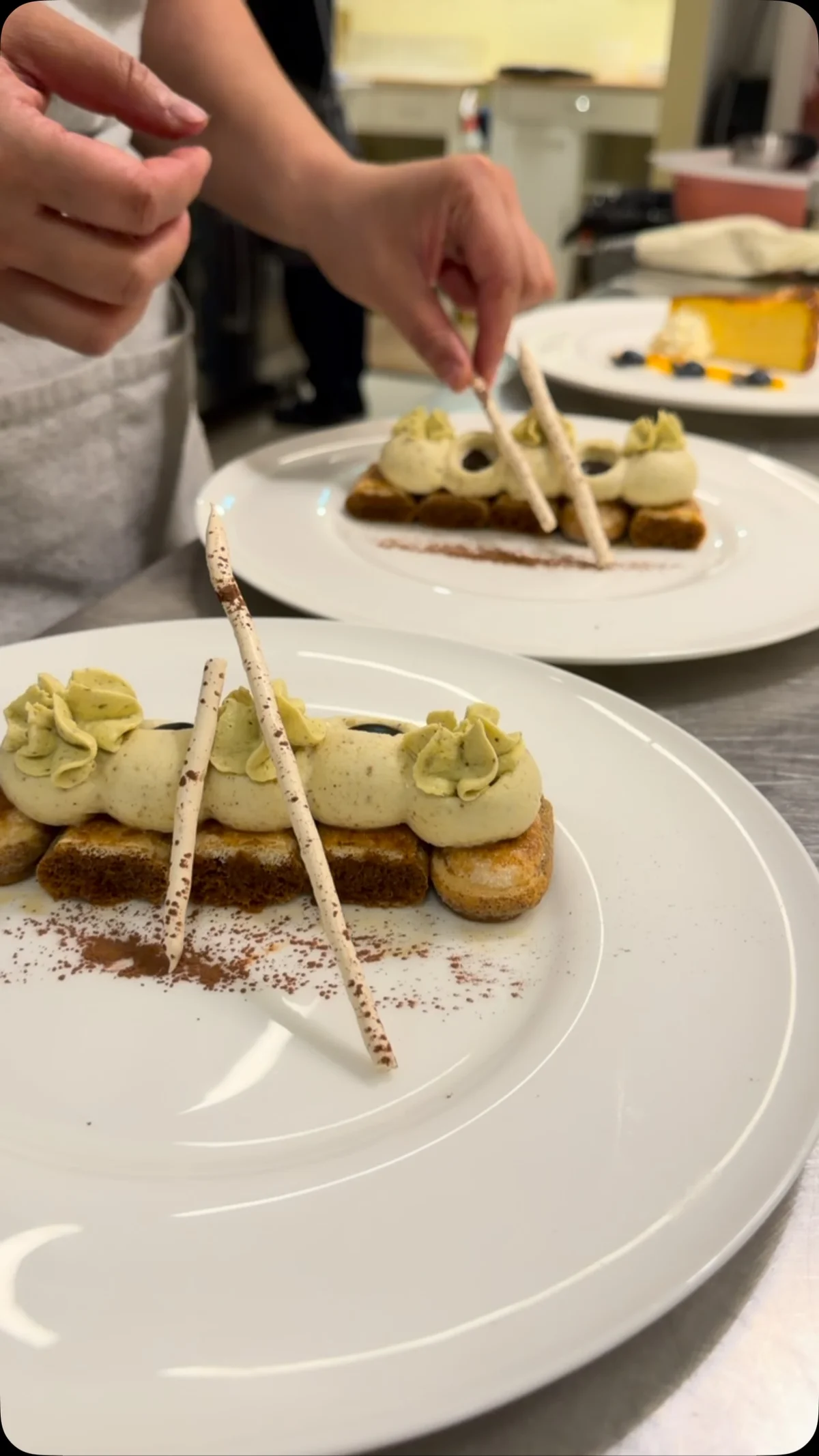 Pistachio tiramisu being plated in Liv’s kitchen