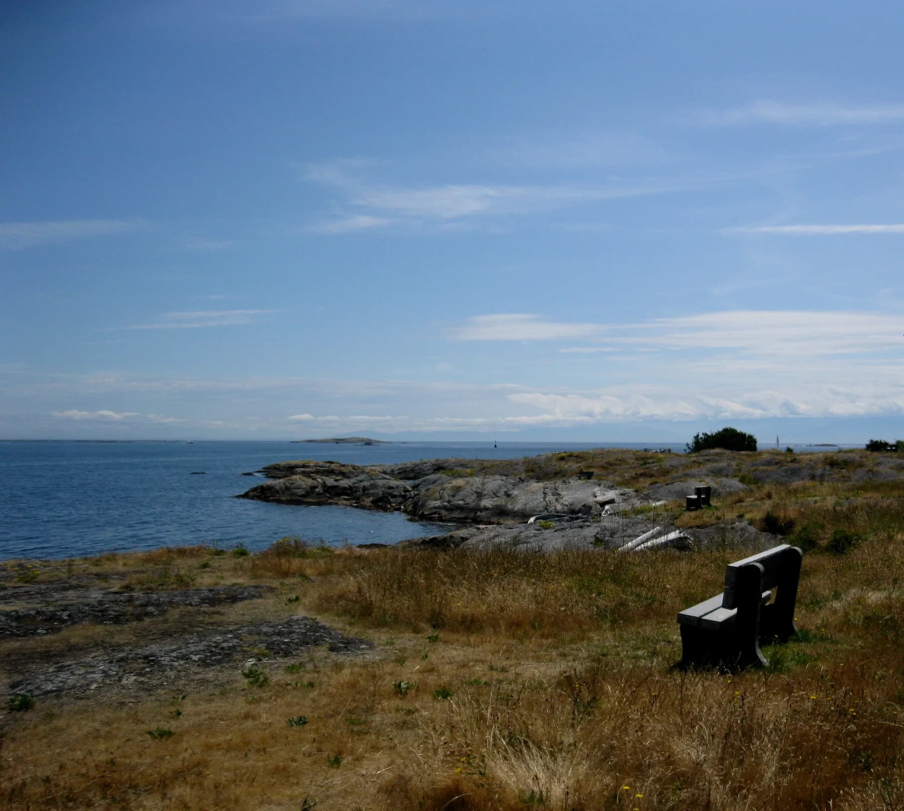 A bench at Cattle Point faces the rocky shoreline and open water