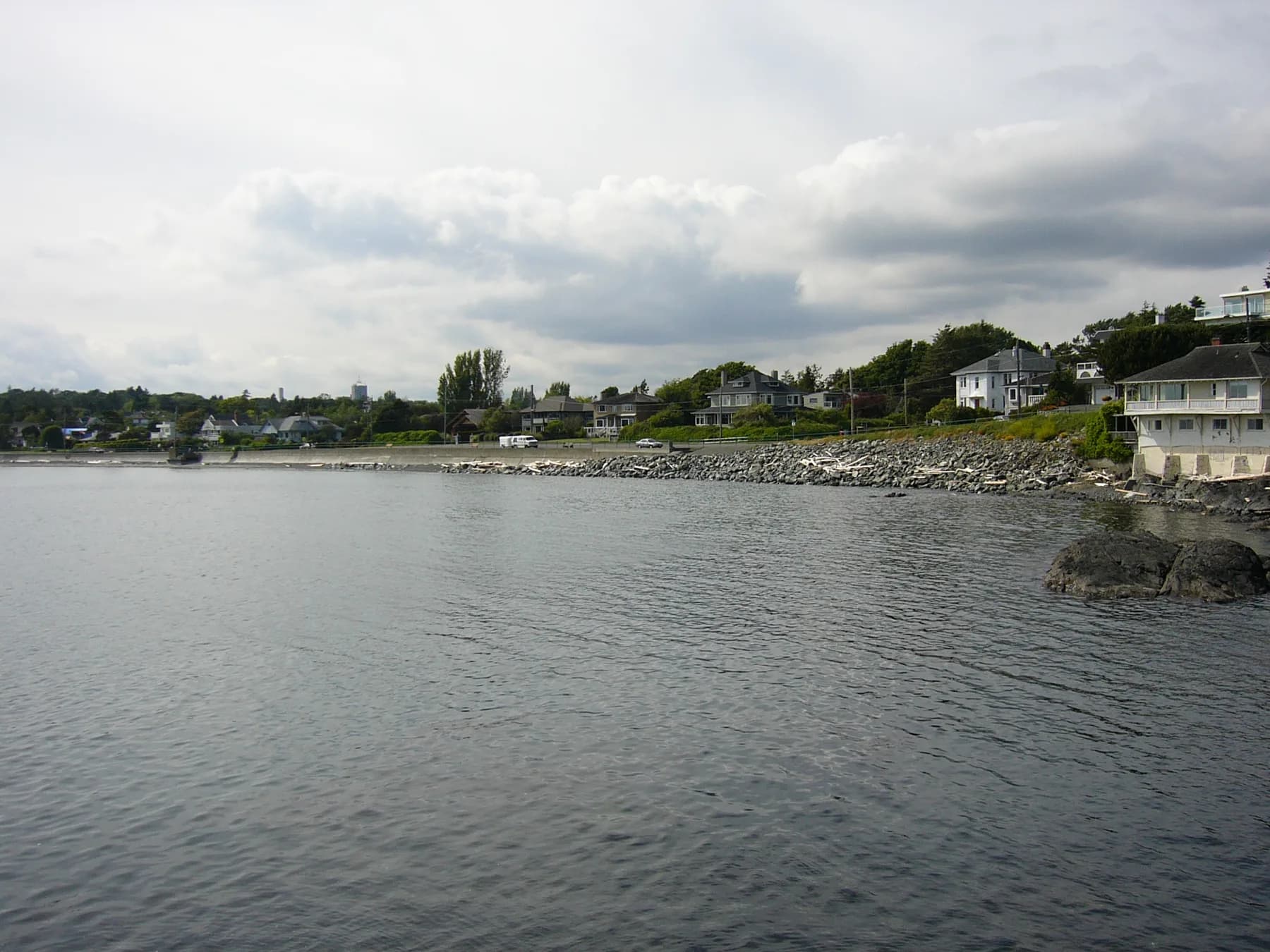 The McNeill Bay esplanade curves along the water beneath a bright sky